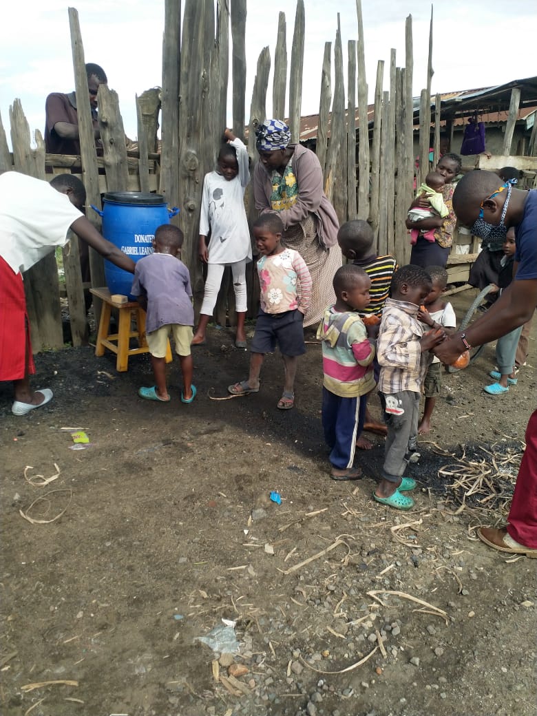 CHILDREN IN THE SLUM AND THEIR COMPOUND LEARN TO WASH THEIR HANDS